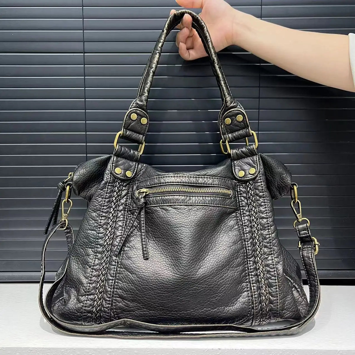 black handbag for school with an exterior zipper pocket